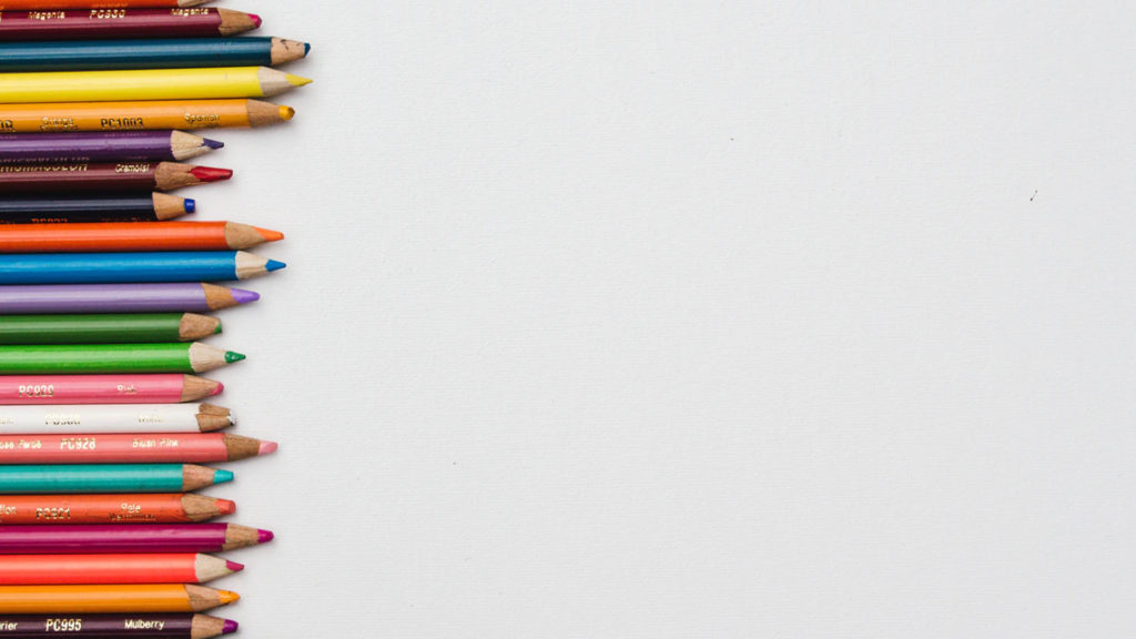 A vertical stack of various colored pencils